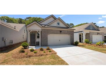 Charming brick home featuring an attached garage and a well-manicured front yard at 2617 Cacao Sq, Acworth, GA 30101