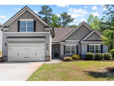 Charming gray two-story home featuring a two-car garage and well-maintained landscaping at 2075 Villa Spring Ct, Dacula, GA 30019