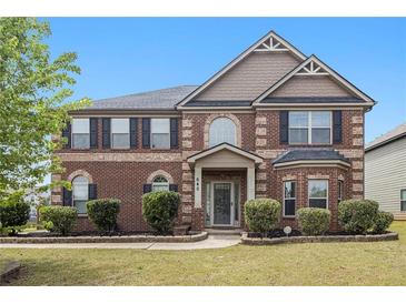 Charming two-story brick home featuring manicured landscaping and a welcoming front porch, enhancing curb appeal at 640 Parkside Place Dr, Mcdonough, GA 30253