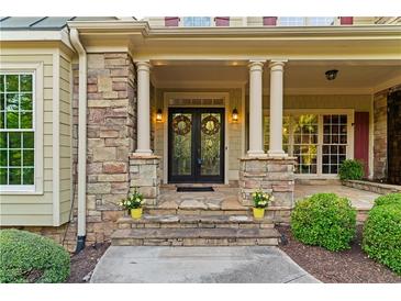 Inviting home entrance with stone accents, double doors, and decorative columns, great curb appeal at 519 River Estates Pkwy, Canton, GA 30115