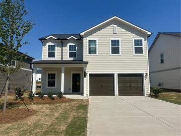 Charming two-story home with a two-car garage and manicured front lawn, perfect for suburban living at 2117 Boxwood Se Cir, Conyers, GA 30094