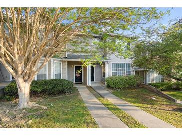Charming townhome exterior with well-manicured lawn and convenient parking spaces at 241 Odyssey Turn Nw, Conyers, GA 30012