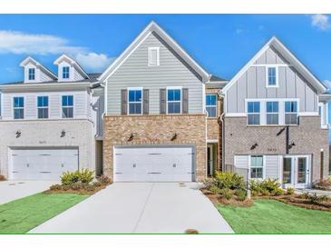 Charming townhomes featuring brick accents, siding, two-car garages and well-manicured landscaping at 5761 Tillman Way, Powder Springs, GA 30127