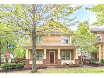 Charming two-story home with a welcoming front porch and manicured lawn at 9912 Mancunian Way, Douglasville, GA 30135