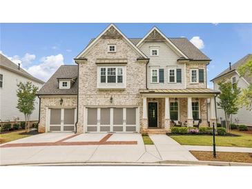Charming two-story home featuring a three-car garage and a beautifully landscaped front yard at 10265 Grandview Sq, Johns Creek, GA 30097