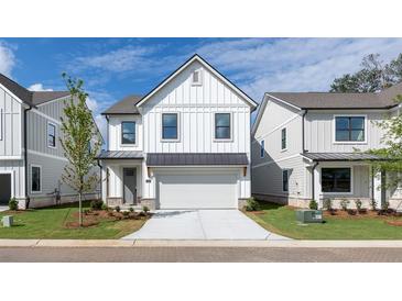 Charming two-story home with white siding, black trim, and a well-manicured front lawn at 1518 Gatekeeper Ter, Marietta, GA 30066