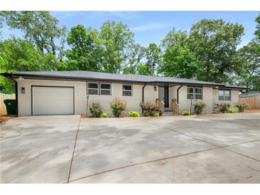 Charming one-story home with painted brick, attached garage, and well-maintained front yard landscaping at 3154 N Druid Hills Rd, Decatur, GA 30033
