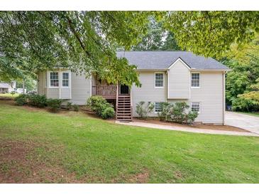 Charming home featuring a well-maintained front yard and inviting entrance staircase at 1152 Bailing Dr, Lawrenceville, GA 30043