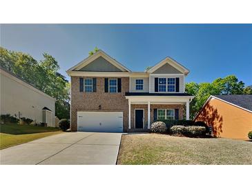 Charming brick two-story home featuring a two-car garage and a well-manicured lawn on a sunny day at 1280 Sw Vonda Ln, Mableton, GA 30126
