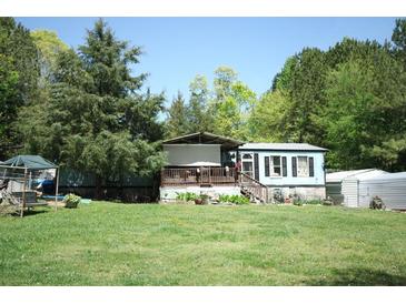Cozy single-story home featuring light blue siding and a covered front porch in a lush, green setting at 31 Dogwood Nw Ln, Cartersville, GA 30121