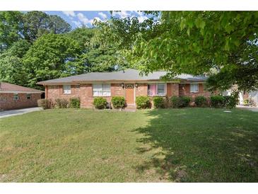 Charming one-story brick home featuring a well-manicured lawn and traditional design at 2844 Whispering Hills Dr, Chamblee, GA 30341