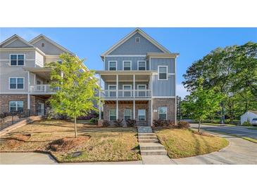 Charming two-story home with a front porch and beautifully landscaped front yard, perfect for curb appeal at 811 Corsiglia Farm, Marietta, GA 30060