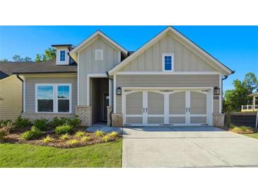 Charming home featuring a two-car garage and a neatly landscaped front yard at 2013 Ripple Park Bnd, Canton, GA 30114