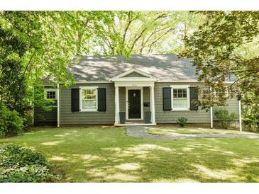 Charming one-story home with beautiful landscaping and a well-manicured lawn at 400 Collier Rd, Atlanta, GA 30309