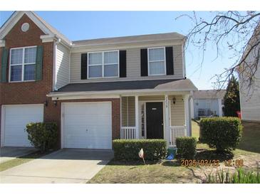 Two-story home with attached garage and well-maintained lawn at 7238 April Ct, Morrow, GA 30260