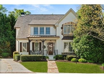 Charming two-story home featuring a stone walkway, lush landscaping, and a welcoming front porch at 3290 Camellia Ln, Suwanee, GA 30024
