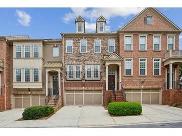 Charming townhomes with brick and stone exteriors, garages, and manicured landscaping at 346 Ardmore Ct, Atlanta, GA 30309
