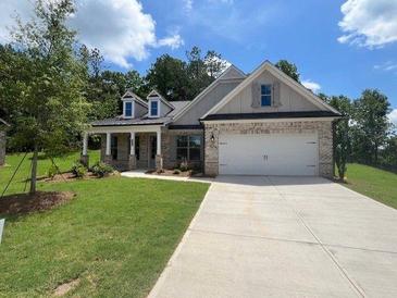 Charming single-story home featuring brick accents, a two-car garage, and a welcoming covered front porch at 350 Brooke View Trl, Canton, GA 30115
