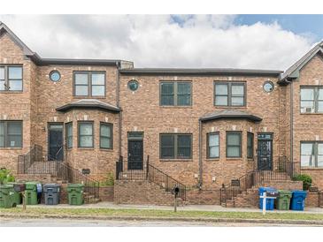 Brick townhomes showing front entrances with wrought iron security doors and stairs at 683 Pryor Sw St # C, Atlanta, GA 30315