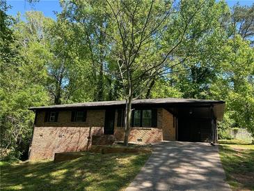 Brick home with a driveway and covered parking at 624 Moselle Sw Dr, Mableton, GA 30126