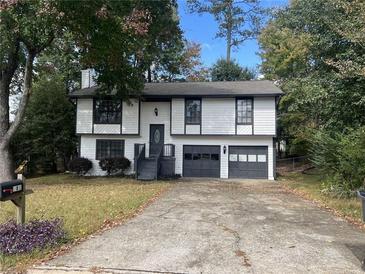 Charming two-story home with a well-manicured lawn and a two-car garage at 981 Dundee Dr, Lilburn, GA 30047