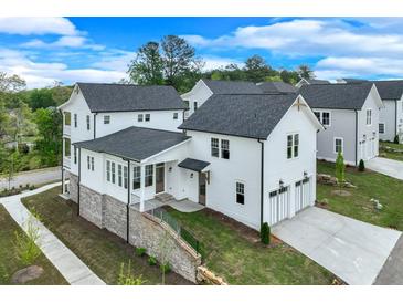 Beautiful two-story home with white siding, black roof and two car garage at 1304 Six Sisters St, Dacula, GA 30019