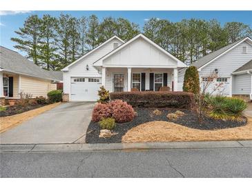 Charming single-story home with a well-manicured lawn, attached garage, and inviting front porch at 142 Jaime Dr, Canton, GA 30114