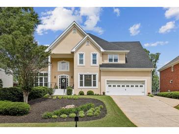 Beautiful home featuring a manicured lawn, fresh landscaping, and attached two-car garage at 5605 Preserve Cir, Johns Creek, GA 30005