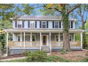 Charming two-story home with a welcoming front porch and beautiful landscaping at 1960 Mceachern Manor Sw Dr, Marietta, GA 30064