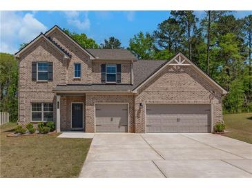 Charming brick two-story home with a two-car garage, landscaped yard, and welcoming front entrance at 420 Tavistock Ct, Mcdonough, GA 30252