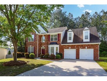 Charming two-story brick home with well-manicured lawn and a two car garage at 3656 Oak Sw Ln, Powder Springs, GA 30127