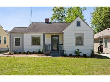 Charming bungalow with a well-manicured lawn and inviting front porch at 1560 Temple Ave, College Park, GA 30337