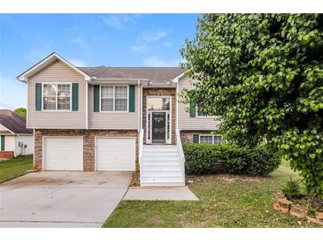 Charming split-level home with stone accents, attached two-car garage, and well-maintained landscaping at 1501 Buckingham Pl, Stockbridge, GA 30281