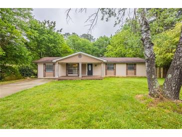 Charming single-story home with a well-manicured lawn and inviting front porch at 110 Valley View Ct, Tyrone, GA 30290