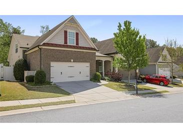 Charming two-story brick home with a well-maintained lawn and a two-car garage, located in a desirable neighborhood at 123 Heritage Pointe, Woodstock, GA 30189