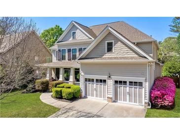 Traditional two-story home featuring a manicured lawn, attached two-car garage, and neutral-colored siding at 2823 Seagrave Way, Marietta, GA 30066