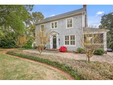 Charming two-story home with gray shingle siding, manicured landscaping and covered porch at 452 Cherokee Ne St, Marietta, GA 30060