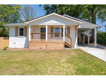 Charming renovated home featuring a wooden porch and convenient carport, perfect for modern living at 1045 Ridgecrest Se Dr, Smyrna, GA 30080