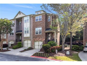 Charming brick townhome with a two-car garage and lovely landscaping at 1976 Cobblestone Ne Cir, Atlanta, GA 30319