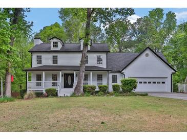 Charming two-story home with a welcoming front porch and a well-manicured lawn, perfect for suburban living at 191 Gates Mill Dr, Lawrenceville, GA 30045