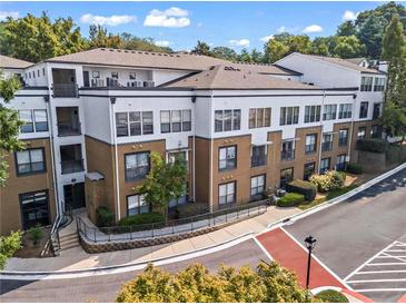 Condominium with three stories, balconies, and professional landscaping and exterior stairwell at 821 Ralph Mcgill Ne Blvd # 2412, Atlanta, GA 30306