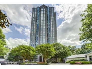 Stunning high-rise building with a unique design surrounded by lush green trees on a partly cloudy day at 2870 Pharr Court S Nw # 1608, Atlanta, GA 30305
