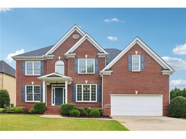 Beautiful two-story brick home with manicured lawn and attached two car garage at 2620 Bent Creek Dr, Cumming, GA 30041