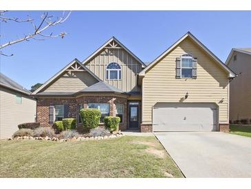 Charming two-story home with a well-manicured lawn and a two-car garage on a sunny day at 3877 Valley Bluff Ln, Snellville, GA 30039