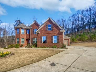 Charming two-story brick home with a well-manicured lawn and inviting curb appeal at 2470 Bridle Bridge Trl, Cumming, GA 30040