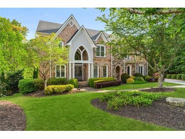 Stunning brick home with meticulously landscaped front yard and mature trees at 3215 Oxleas Ct, Cumming, GA 30041