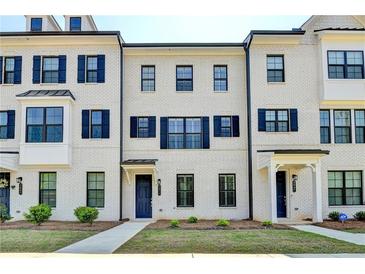 Charming white brick townhome featuring black shutters, black trim, and a stylish dark blue front door at 3677 Sorrel Ln, Duluth, GA 30096