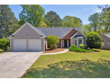 Charming single-story home with a two-car garage, well-manicured lawn, and mature trees in a serene suburban setting at 5630 Tallantworth Xing, Cumming, GA 30040
