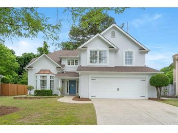 Inviting traditional two-story home featuring a well-maintained lawn, two-car garage, and a charming blue front door at 2263 Seatton Ct, Marietta, GA 30062