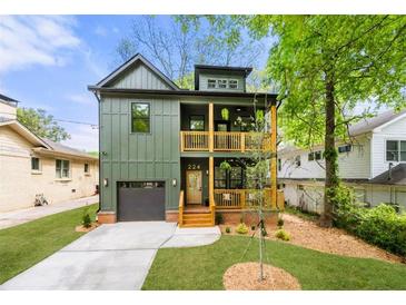 Charming two-story home with olive green siding, a black roof, and double stacked, wood-railed front porches at 224 Cambridge Ave, Decatur, GA 30030